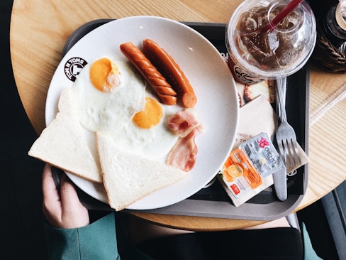 two sunny side up eggs on white plate