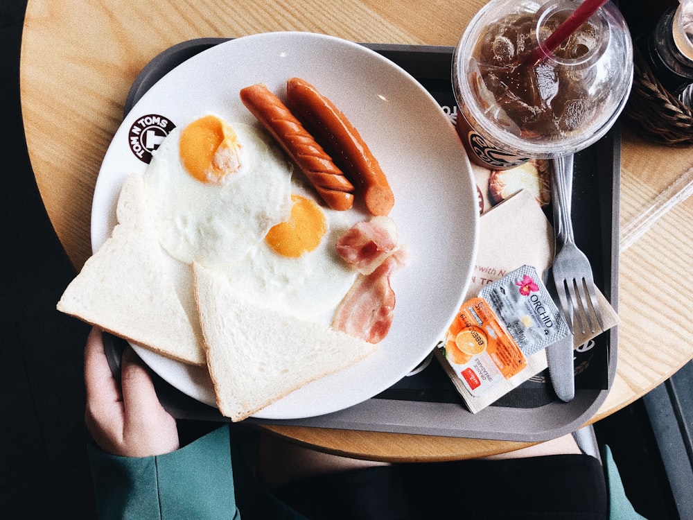 two sunny side up eggs on white plate