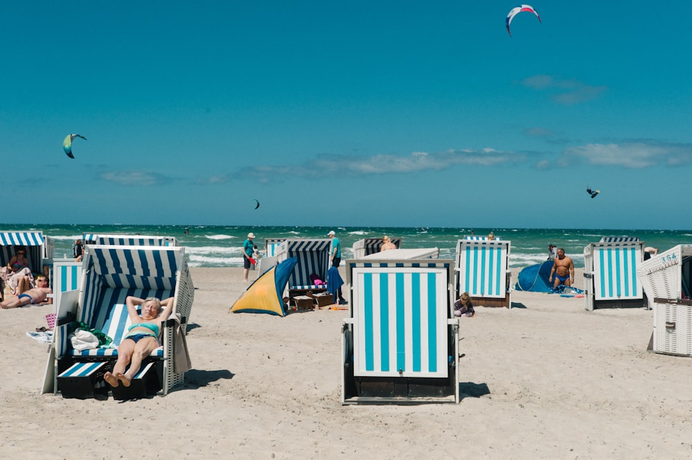 people lying on lounger near sea