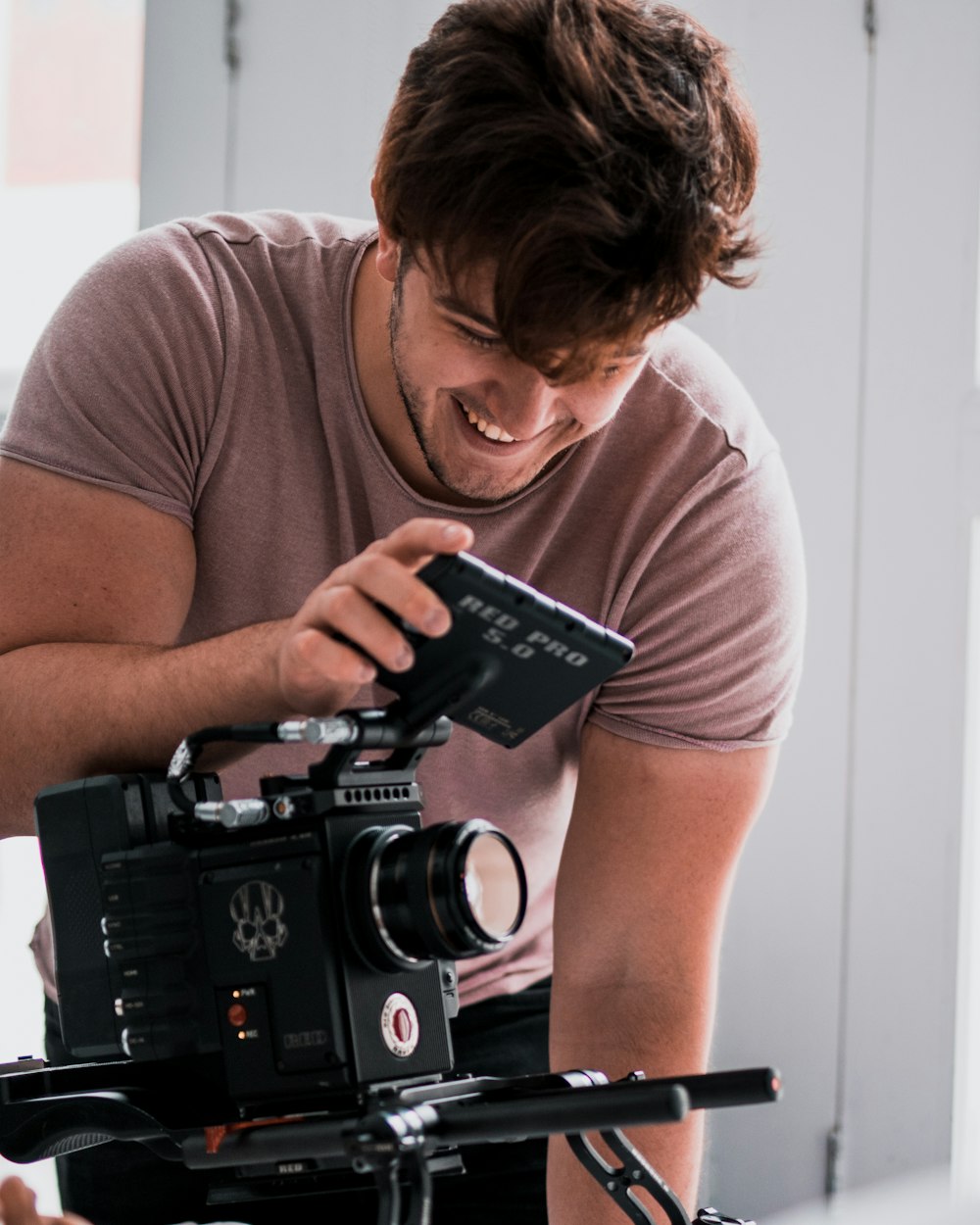 smiling man using video camera