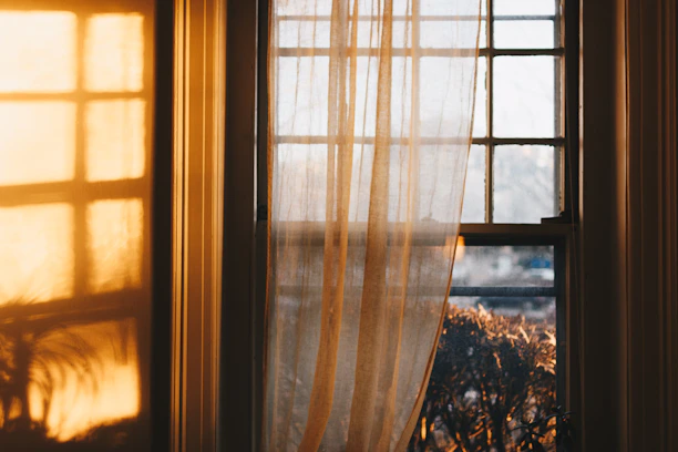 A soothing therapy room featuring warm golden yellow and red accents with natural light filtering through.
