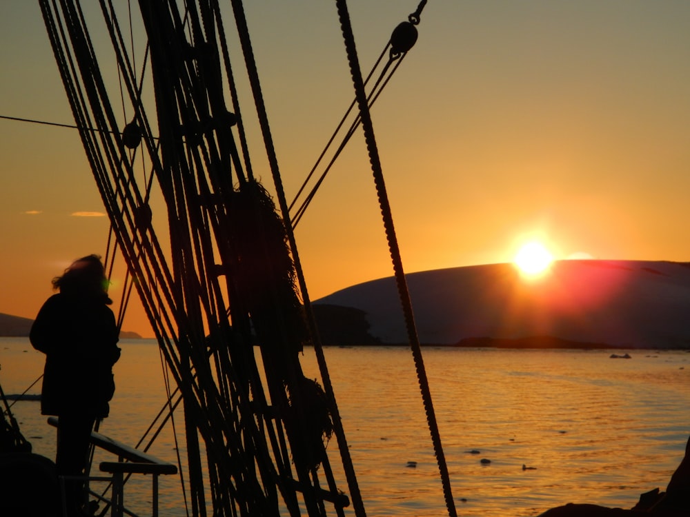 silhouette of man standing on ship