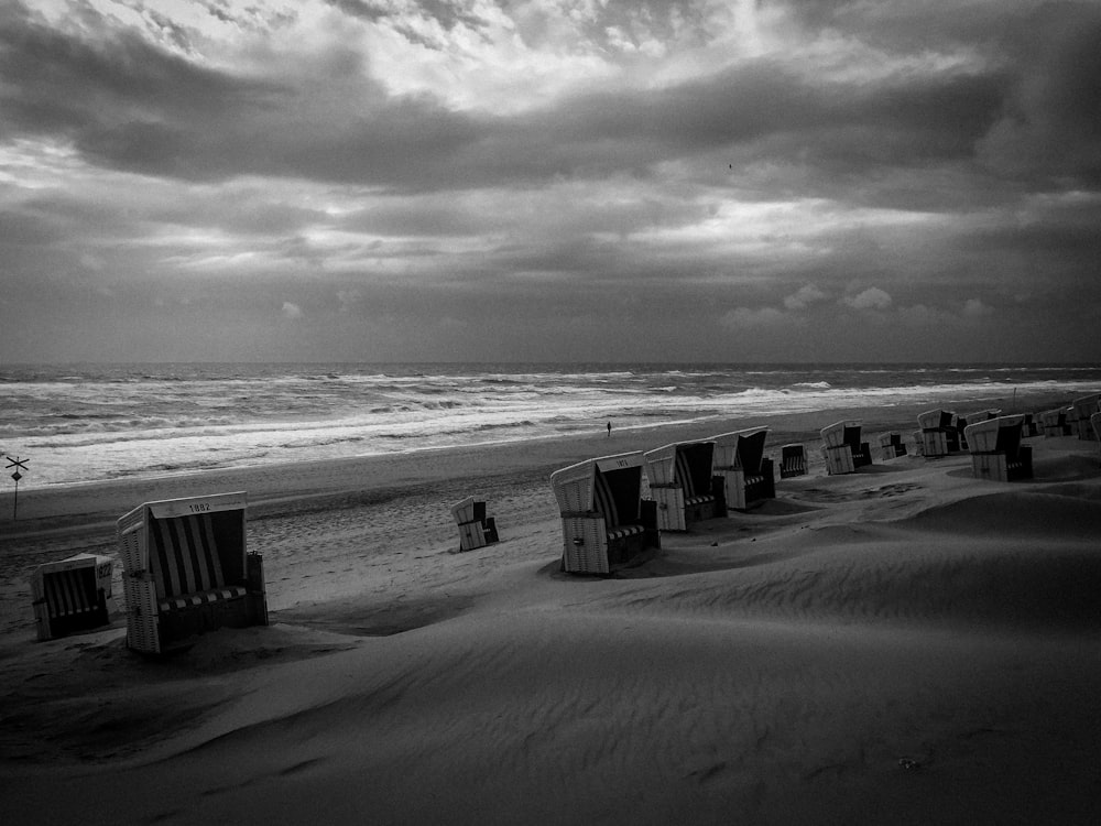 grayscale photo of boxes near shore