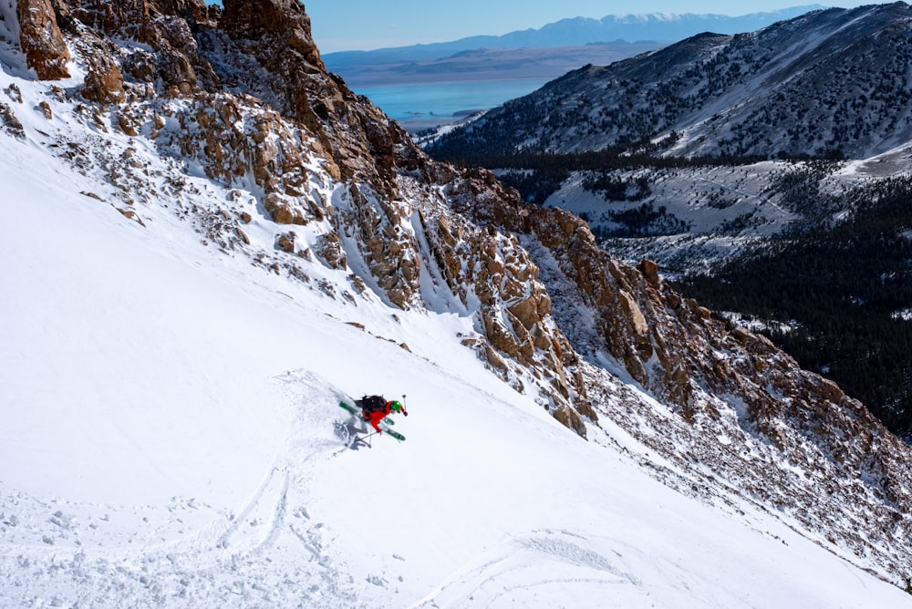 person on snowfield near mountain during daytime