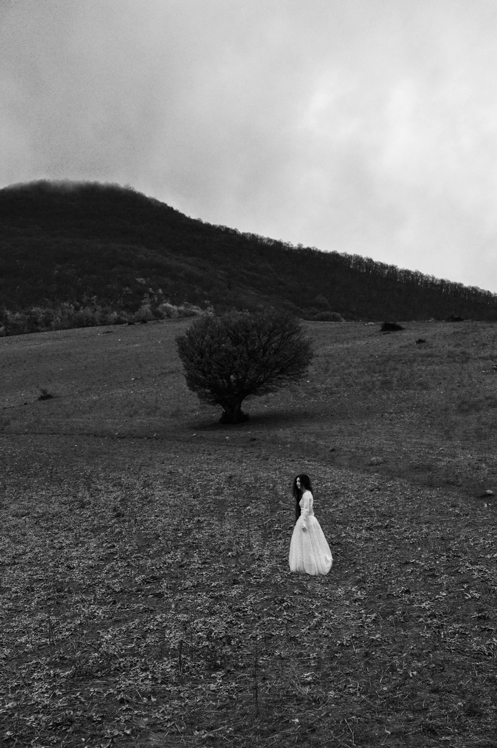 woman standing in middle of field during daytime