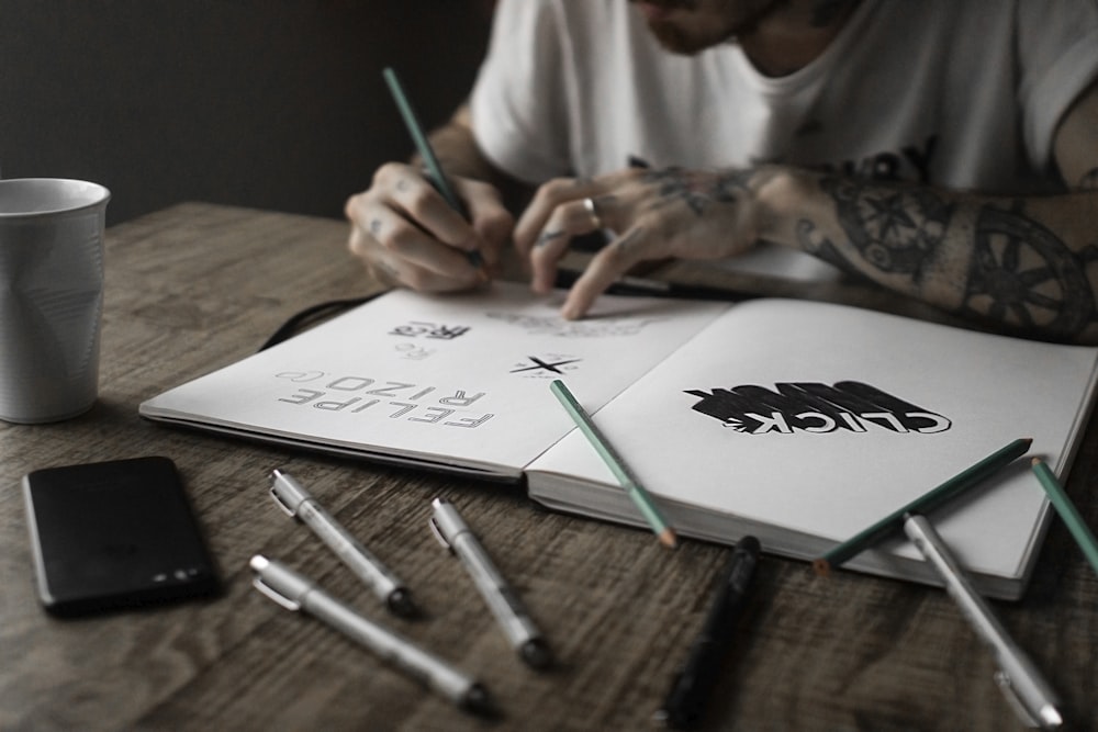 person writing on book