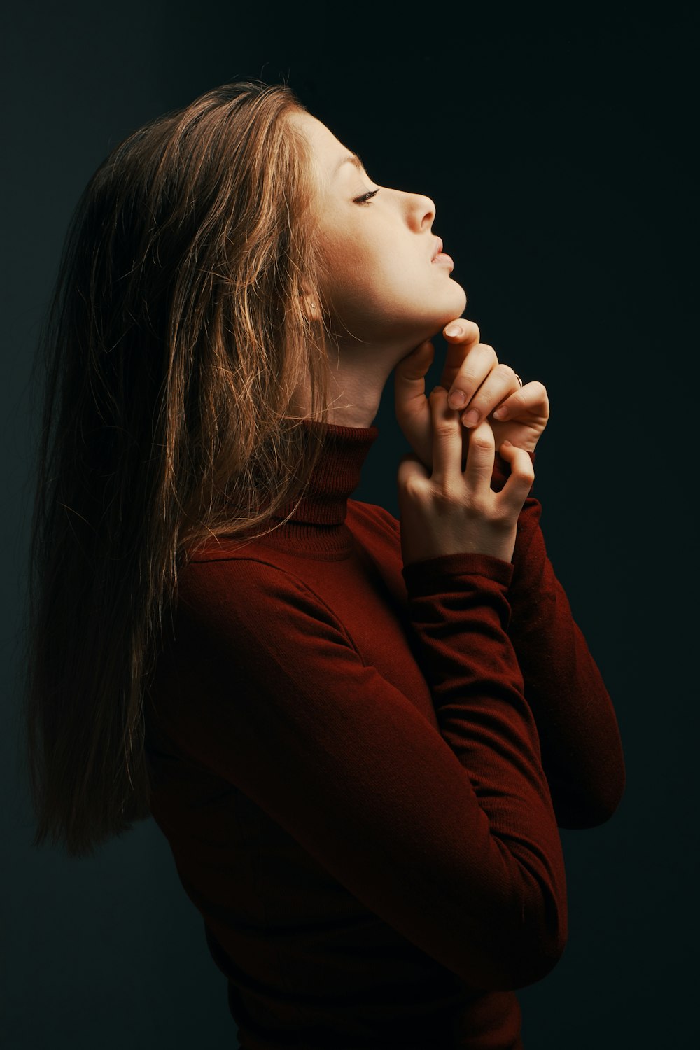 woman in red sweatshirt with eyes closed