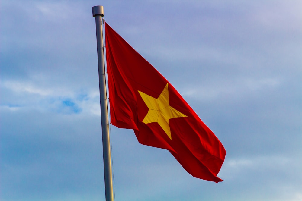 red and yellow flag with star on pole