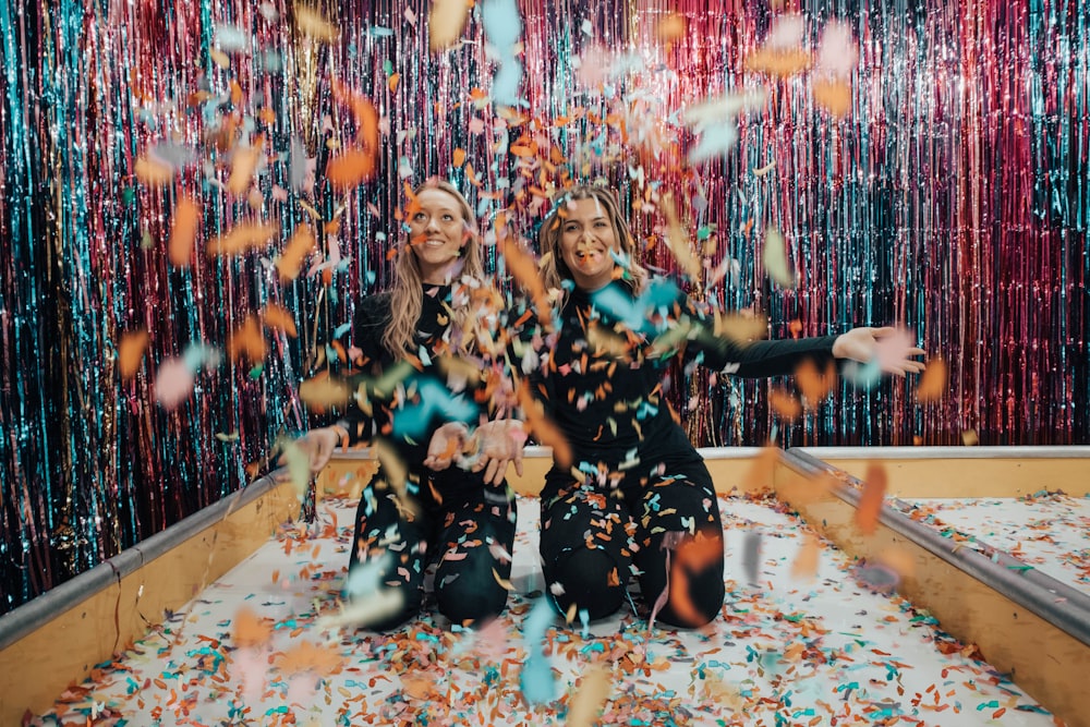 two women enjoying confetti