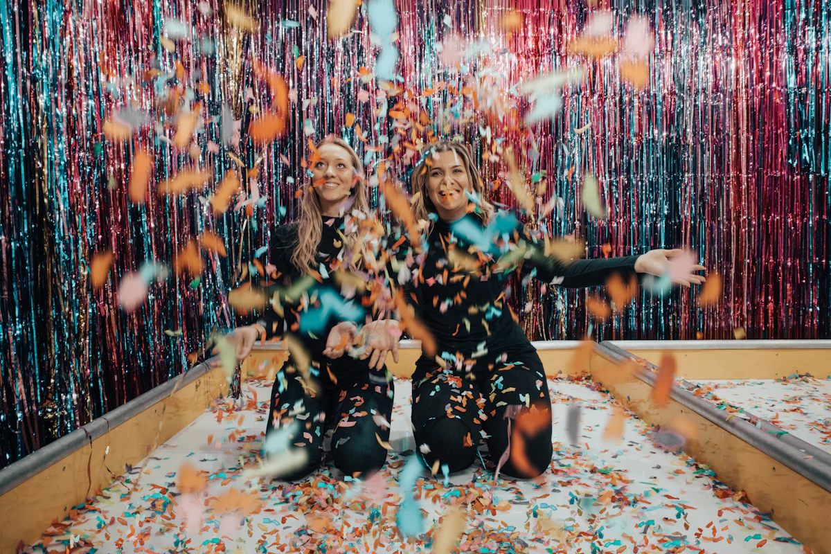 two women enjoying confetti