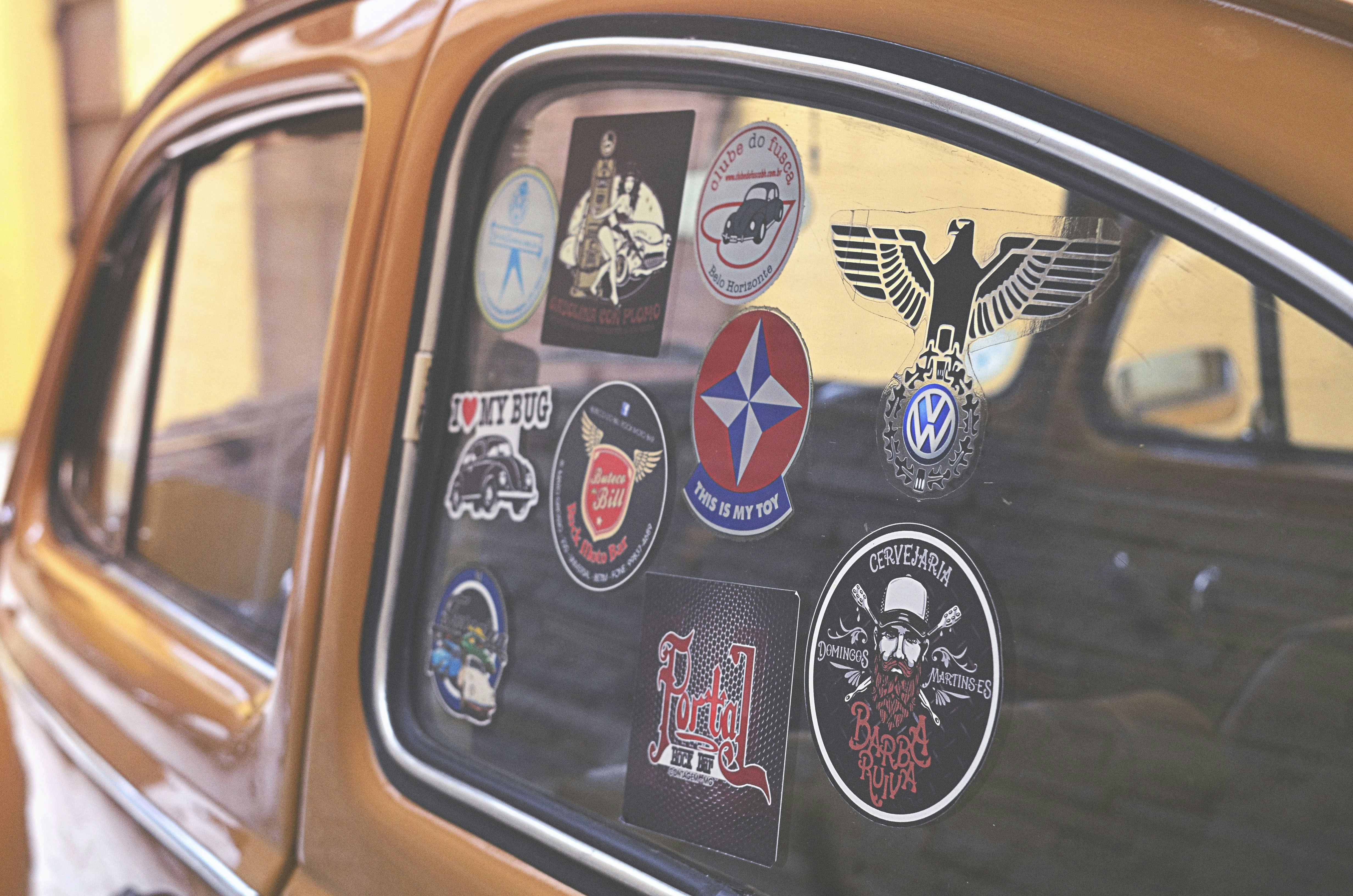 closeup photo of assorted-design decals on vehicle window