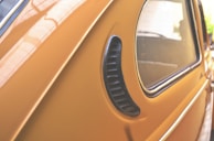 Before and after shots of a dented car side panel restored and freshly painted