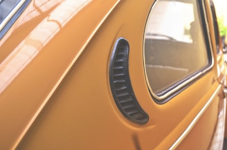 Close-up of a sleek vehicle wrap in black and orange colors on a company van.