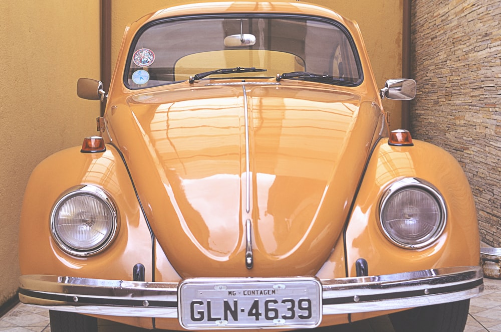 yellow Volkswagen Beetle parked inside room