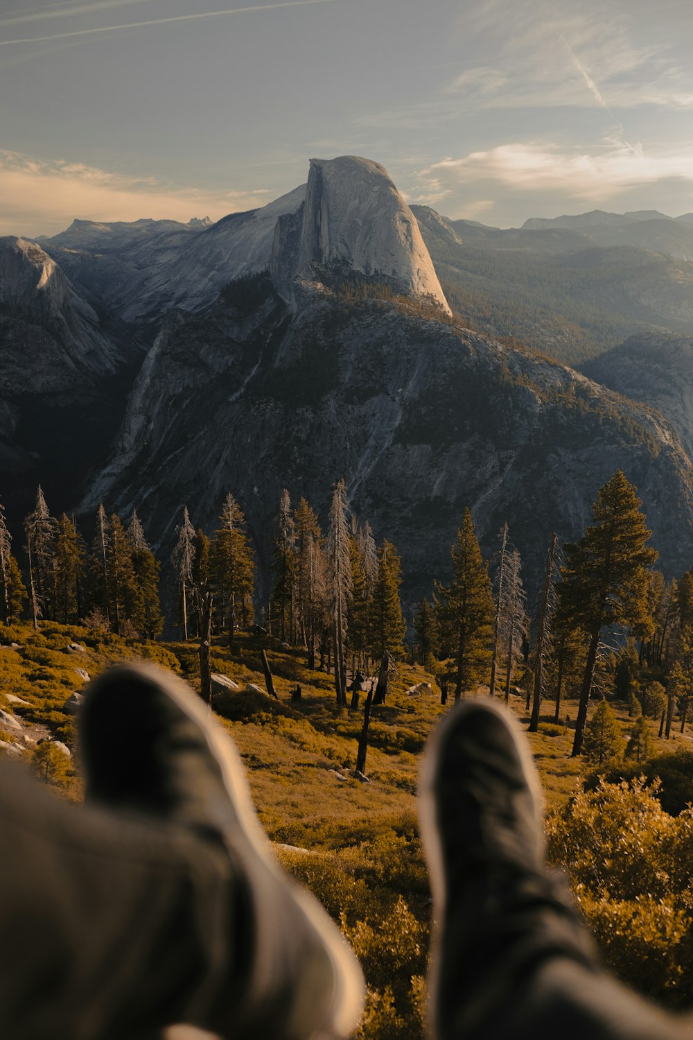 selective focus photography of person wearing black pants and pair of black shoes