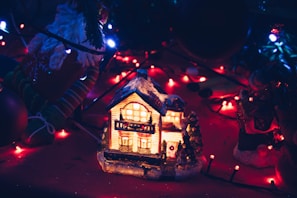 A cozy home corner decorated with AlbertoB LLC’s eco-friendly Christmas sets, glowing softly in the evening light.