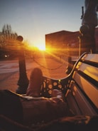 Close-up of durable tactical boots resting on desert sand at sunset.