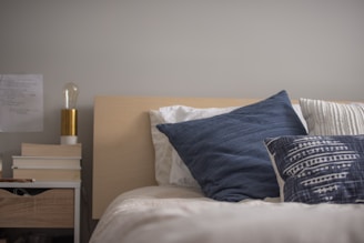 A cozy bedroom setup showcasing a neatly made bed with plush mattress and elegant bedding.