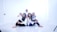 Five women are sitting together on the floor in a bright, minimalistic setting. They are wearing white tops and jeans, with some wearing headscarves. They appear happy and relaxed, with some of them embracing each other.
