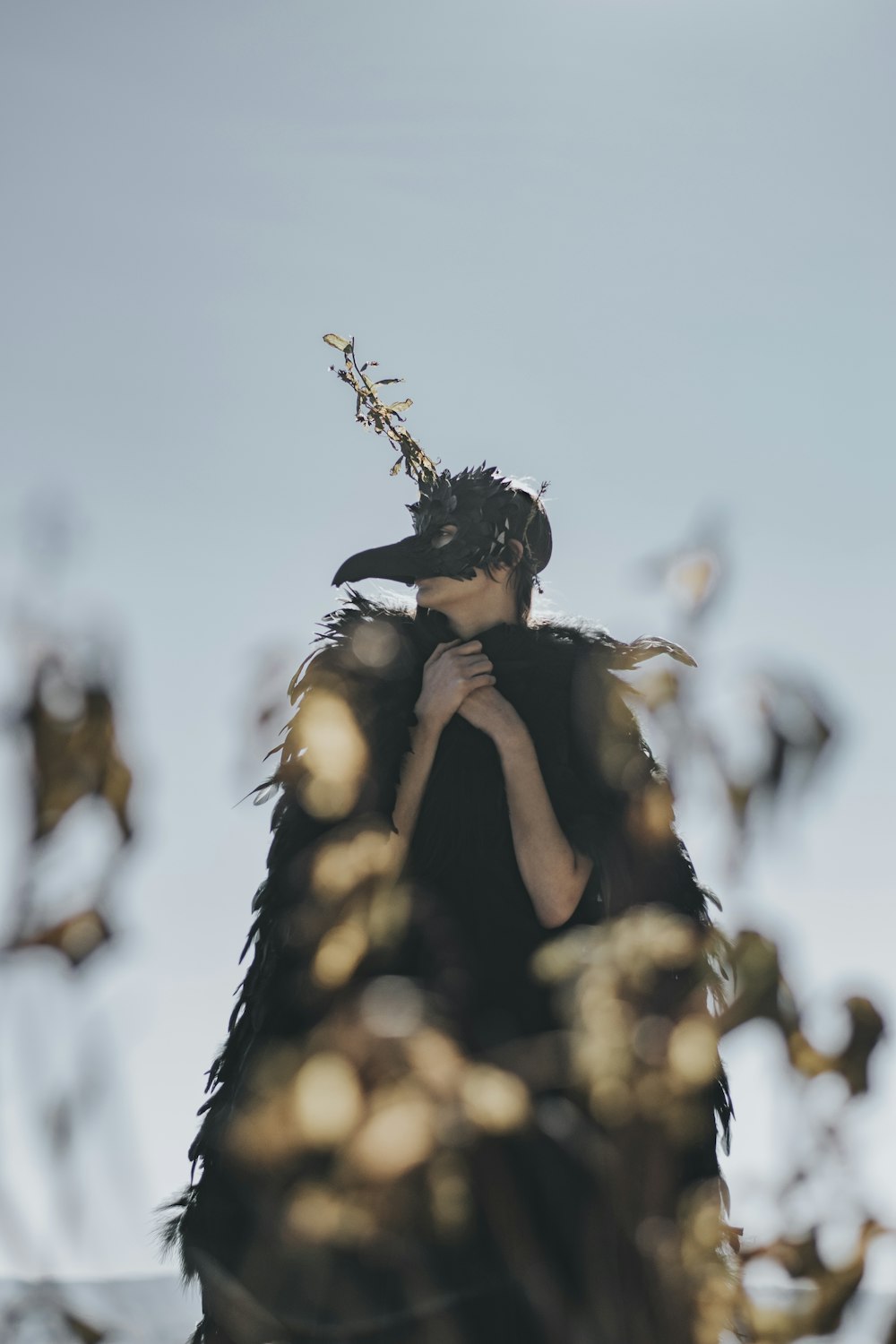 woman wearing black crow costume