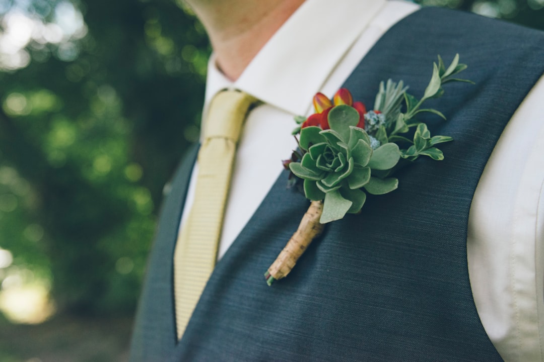 man wearing green succulent brooch