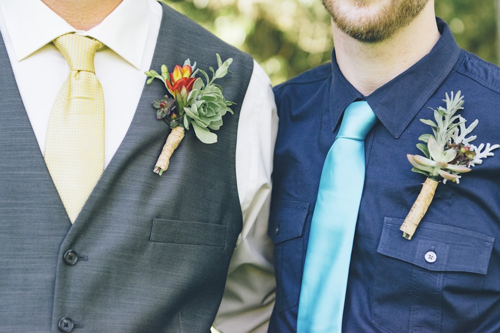 men wearing ties and flower jewelries