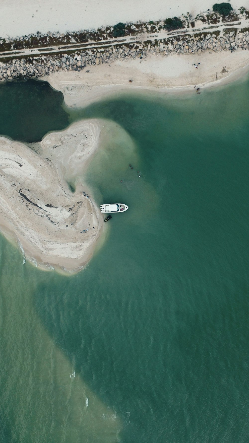 aerial photography of white boat on shoreline