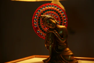 A serene brass Krishna idol glowing softly in natural light, inviting connection.