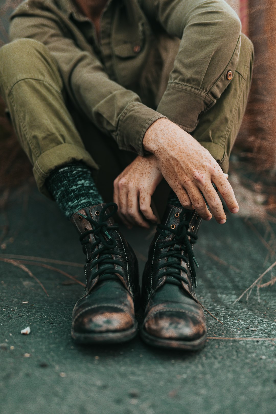 sitting man wearing black combat boots