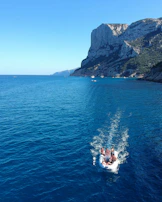 A group of friends enjoying a boat ride with clear blue skies.