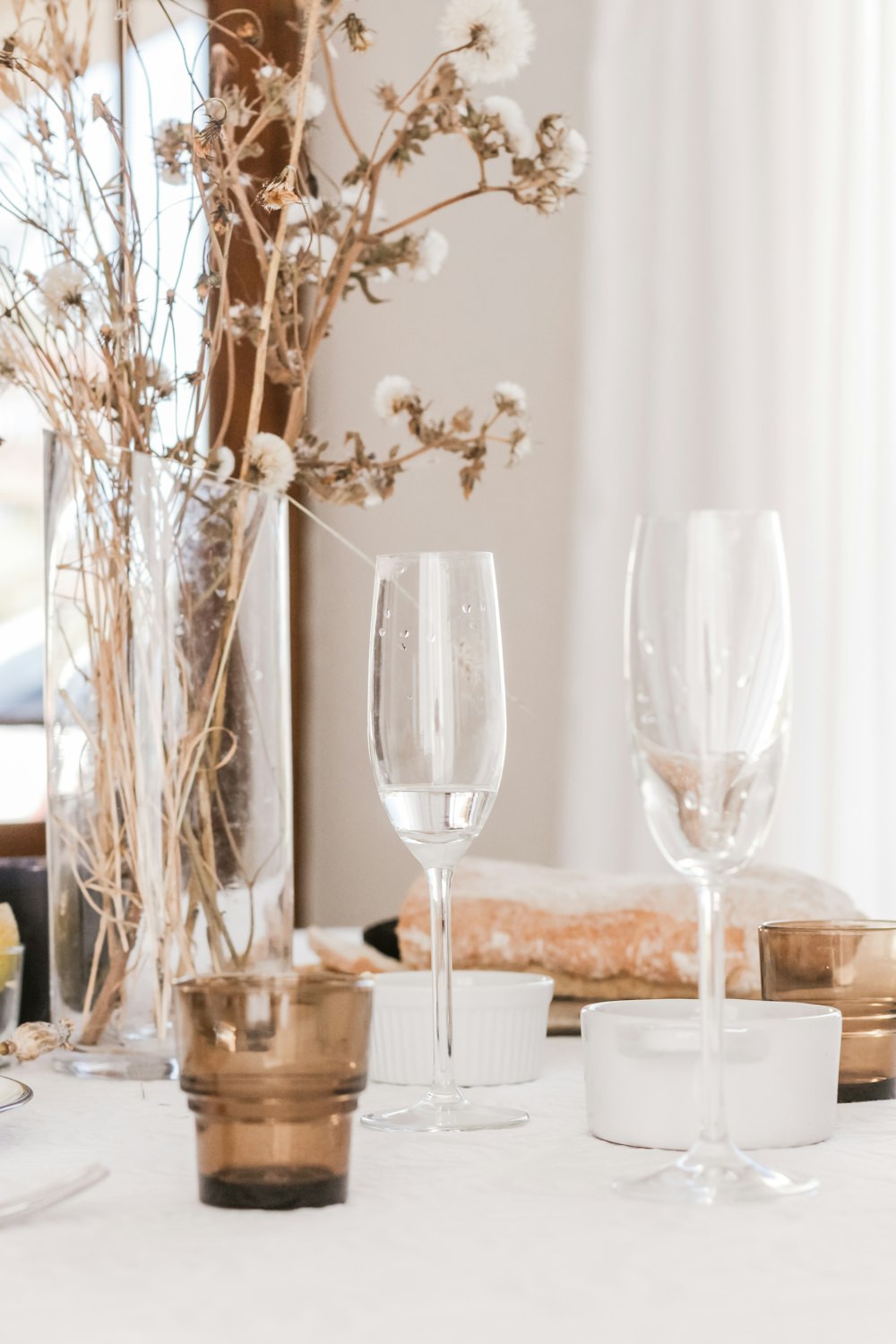champagne glasses beside flower centerpiece
