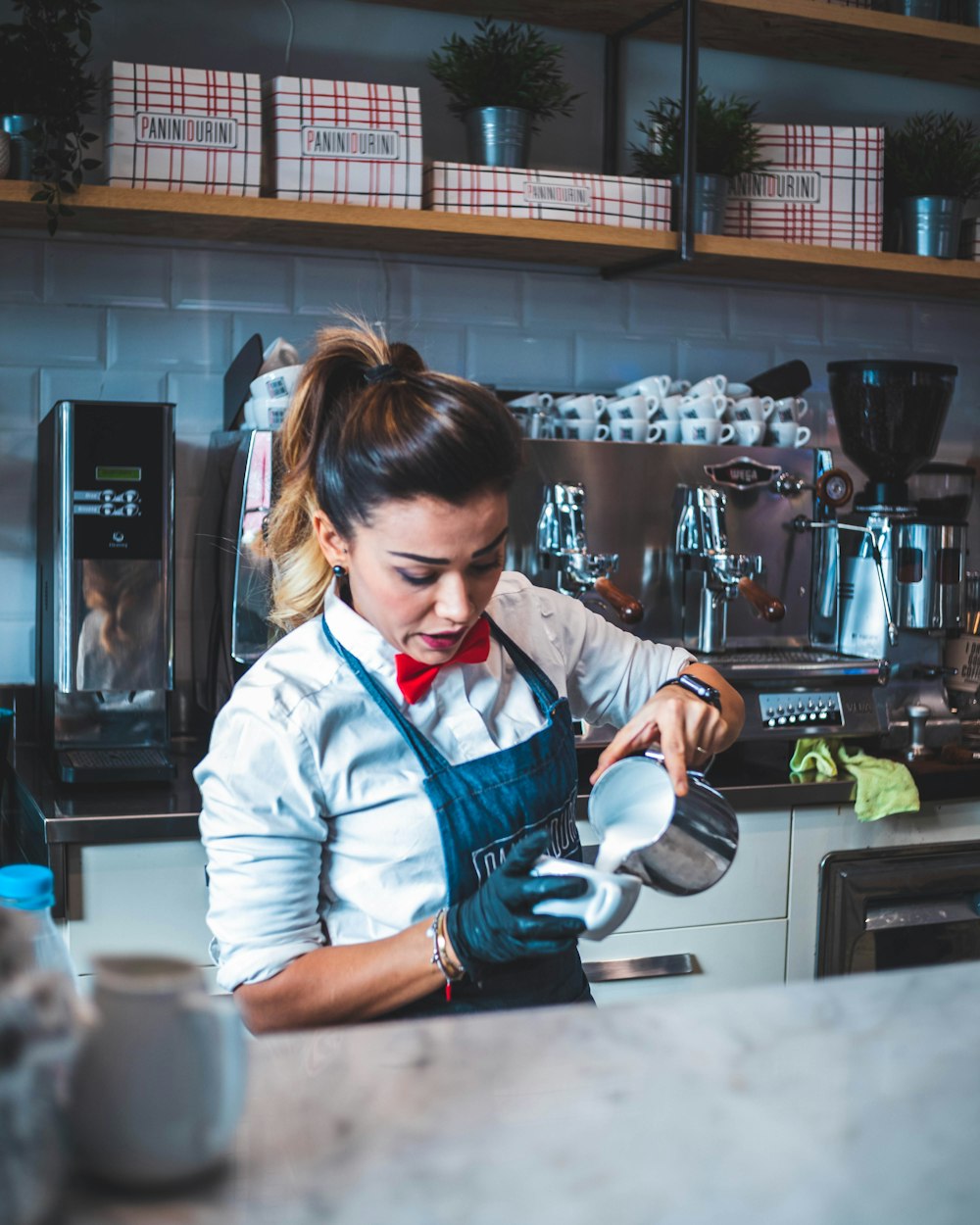 woman pouring liquid on mug