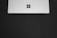 A sleek laptop displaying a modern website design on a minimalist desk.