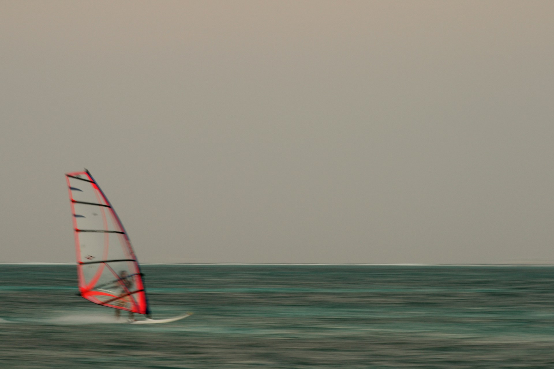 man riding parasail boat in sea