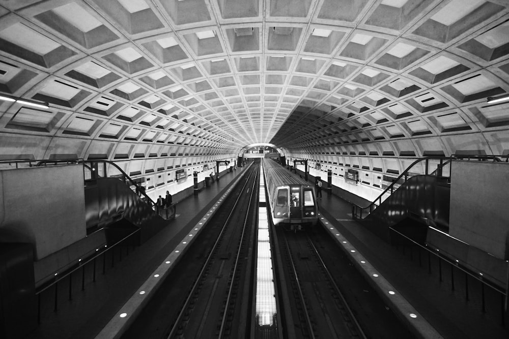 greyscale photography of train in train station