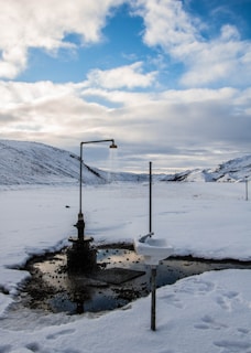 A clean, modern portable shower unit set up outdoors on a sunny day.