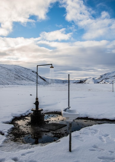 A clean, modern portable shower unit set up outdoors on a sunny day.
