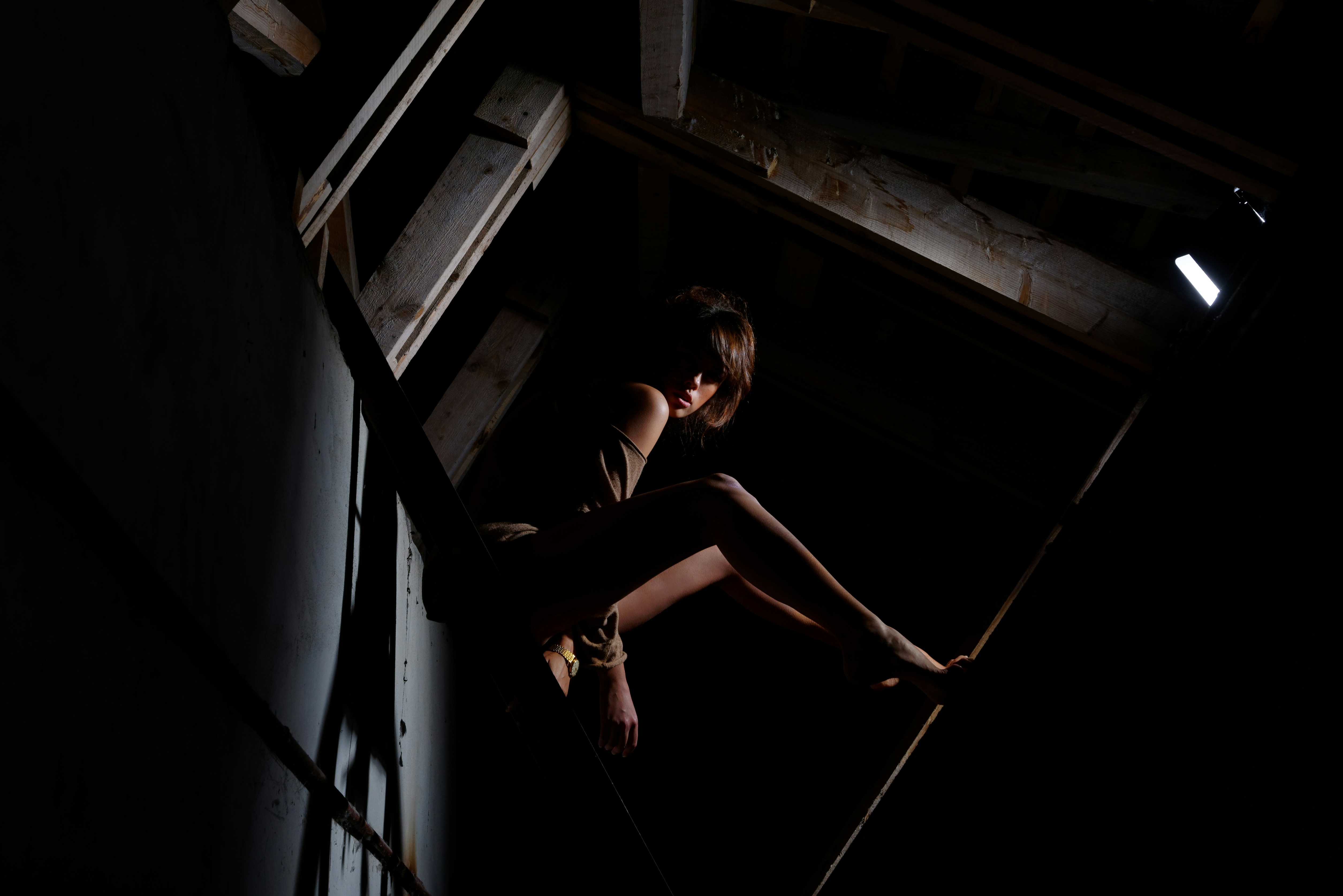 woman sitting inside room with low light, Victoria