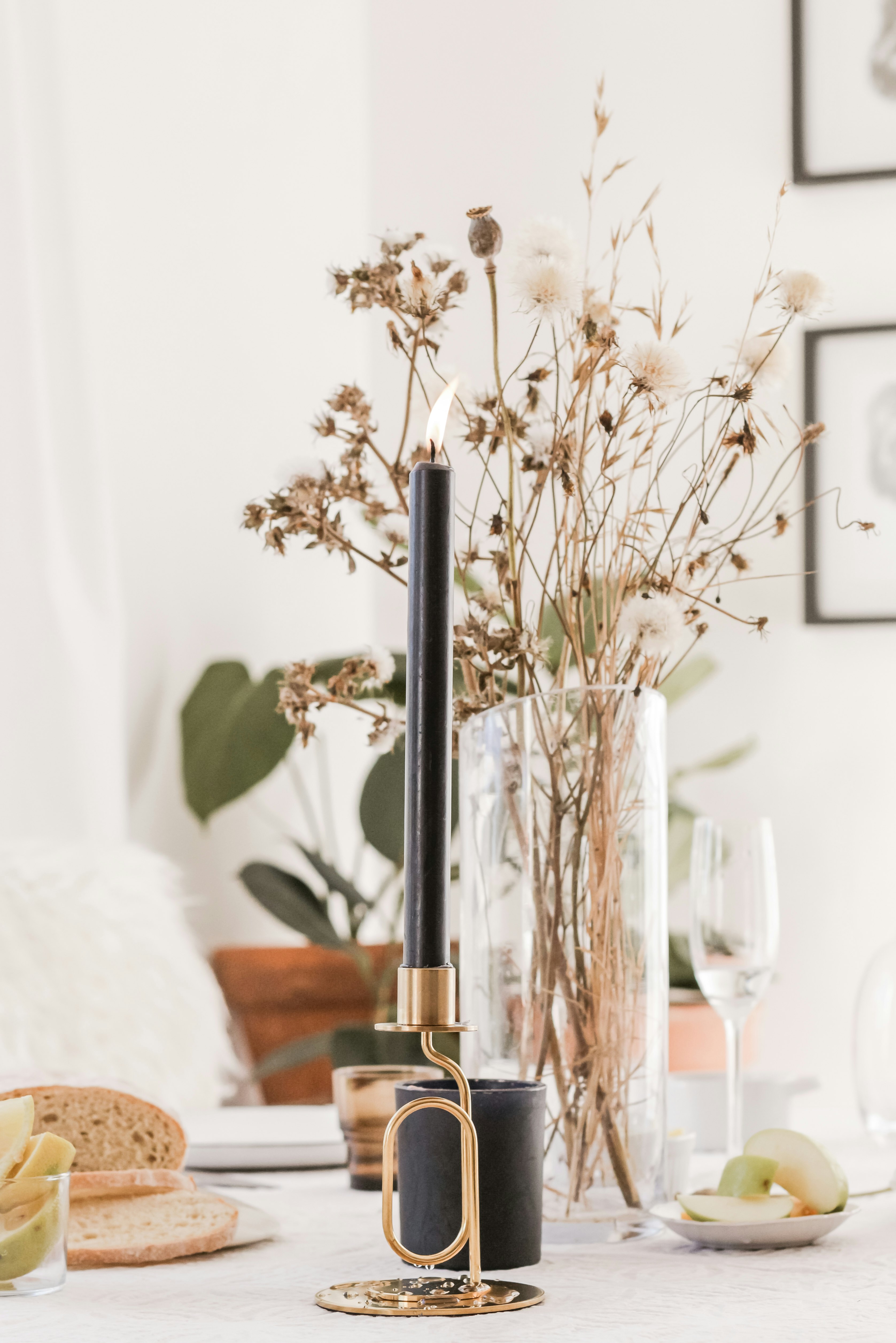 black and gold candle stick on white wooden table