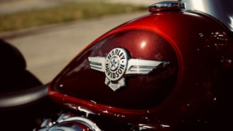 Close-up of a shiny red motorcycle fuel tank freshly detailed at Carz Biker Studio.