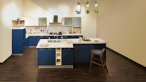A beautifully renovated kitchen showcasing clean lines and soft blue accents.
