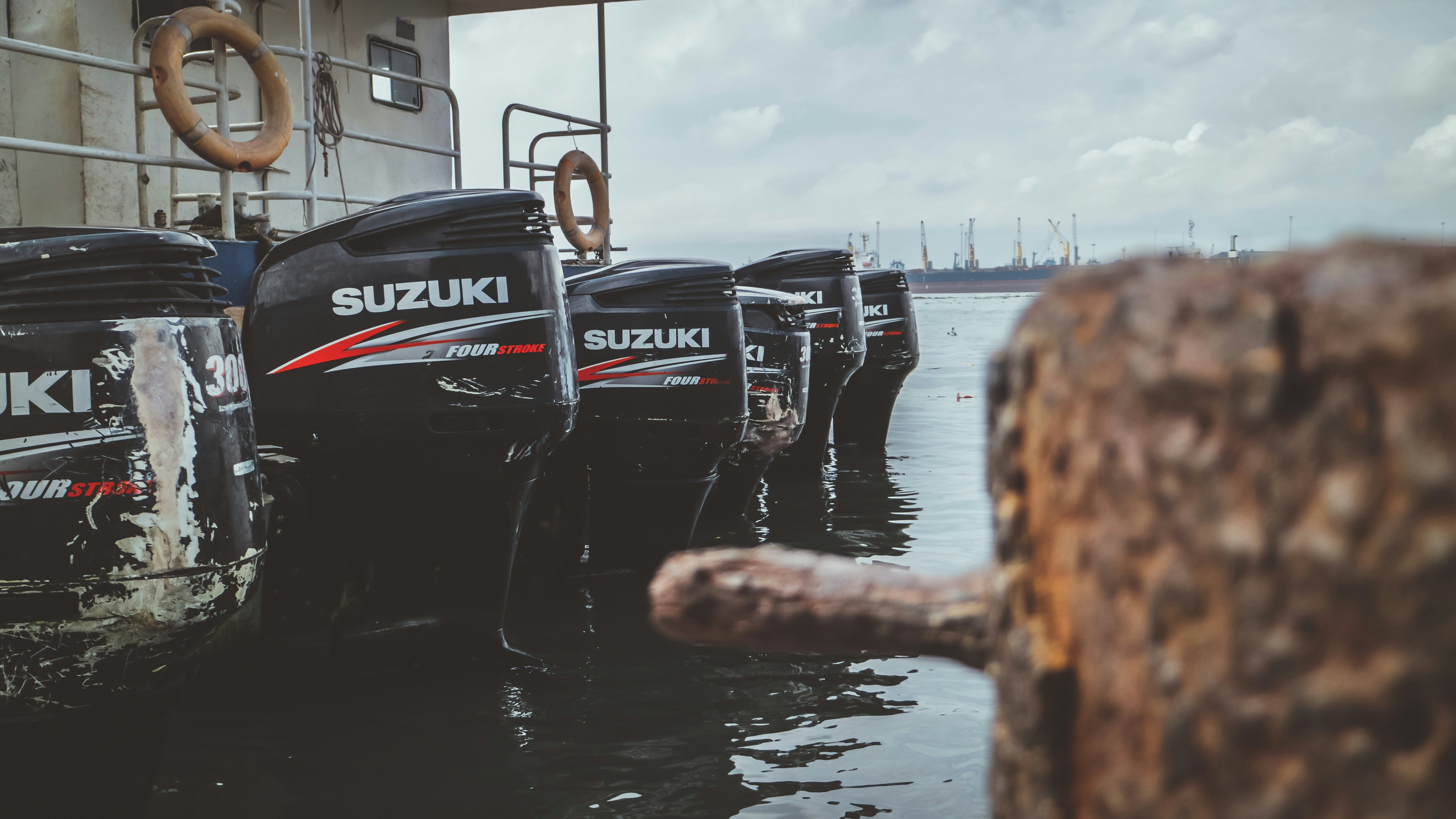 several Suzuki boat motors in selective focus photography