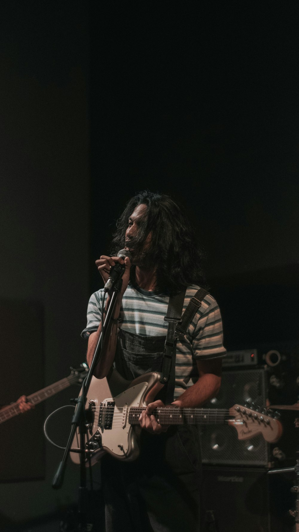 man singing while playing guitar