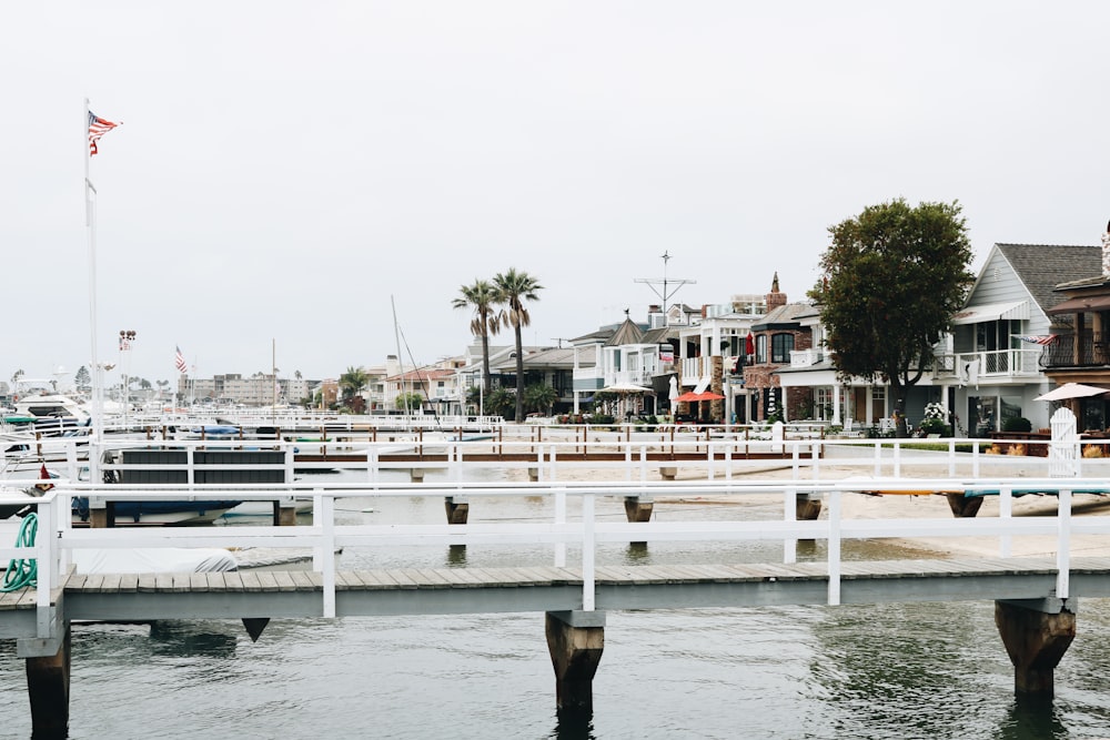 white wooden dock near houses