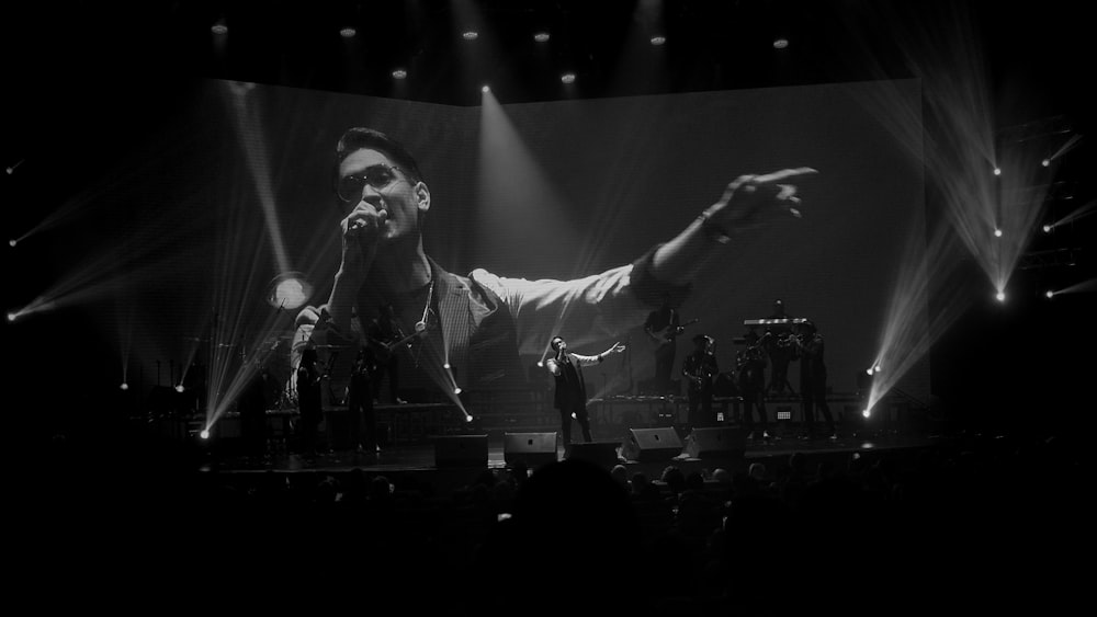 man singing on stage