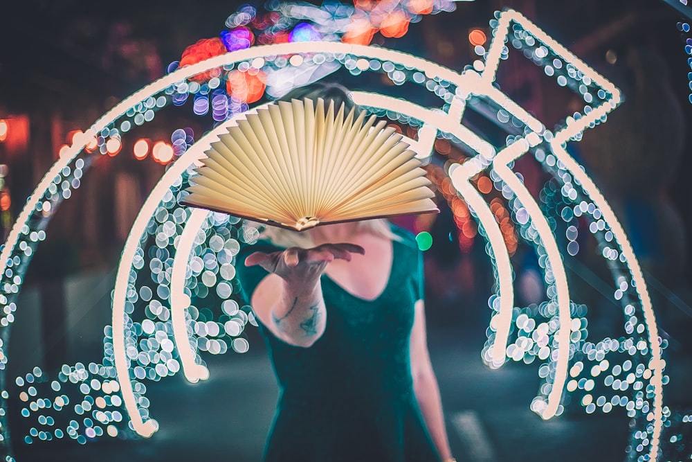 person showing white folding fan