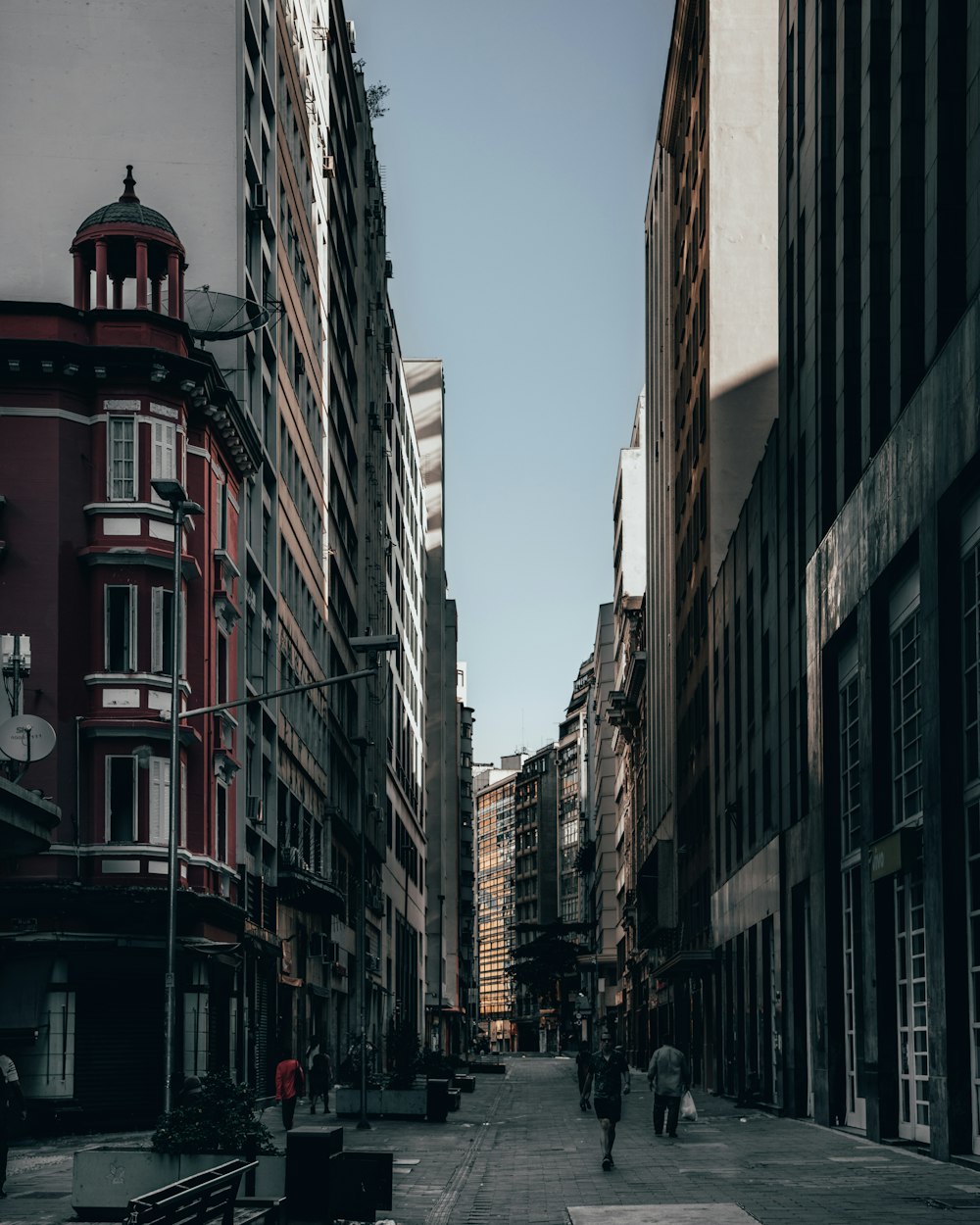 person walking between buildings