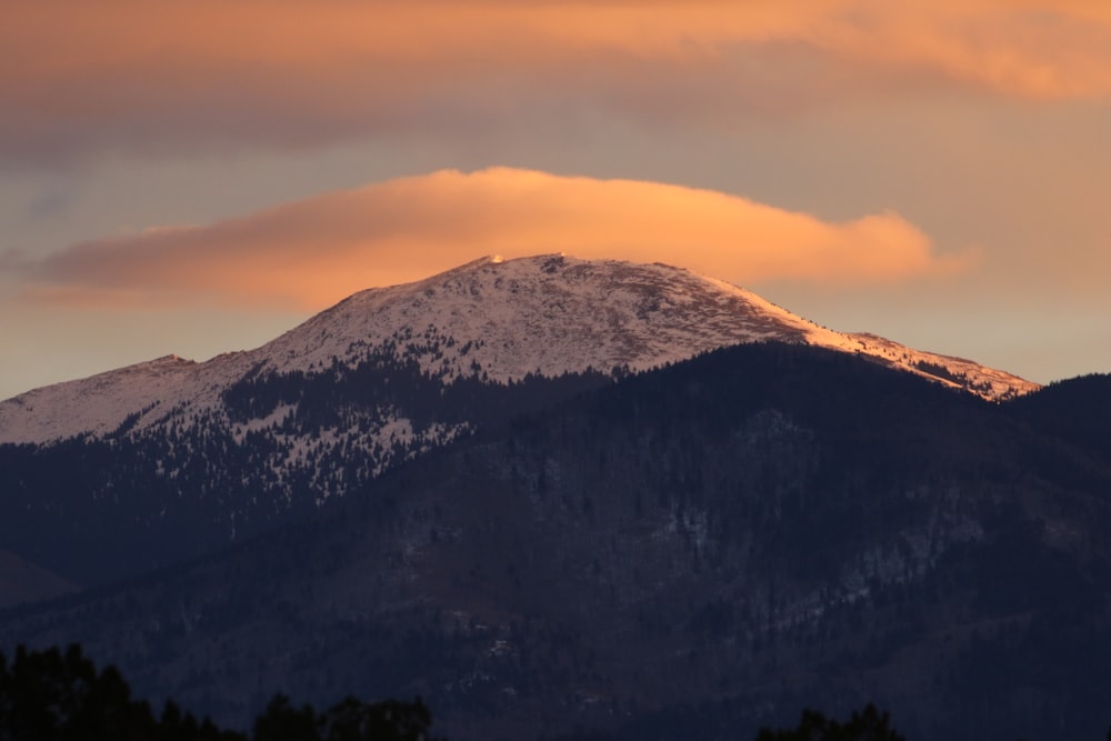 snow covered mountain under white cloudy sky