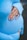 woman holding her belly while wearing blue knit sweater