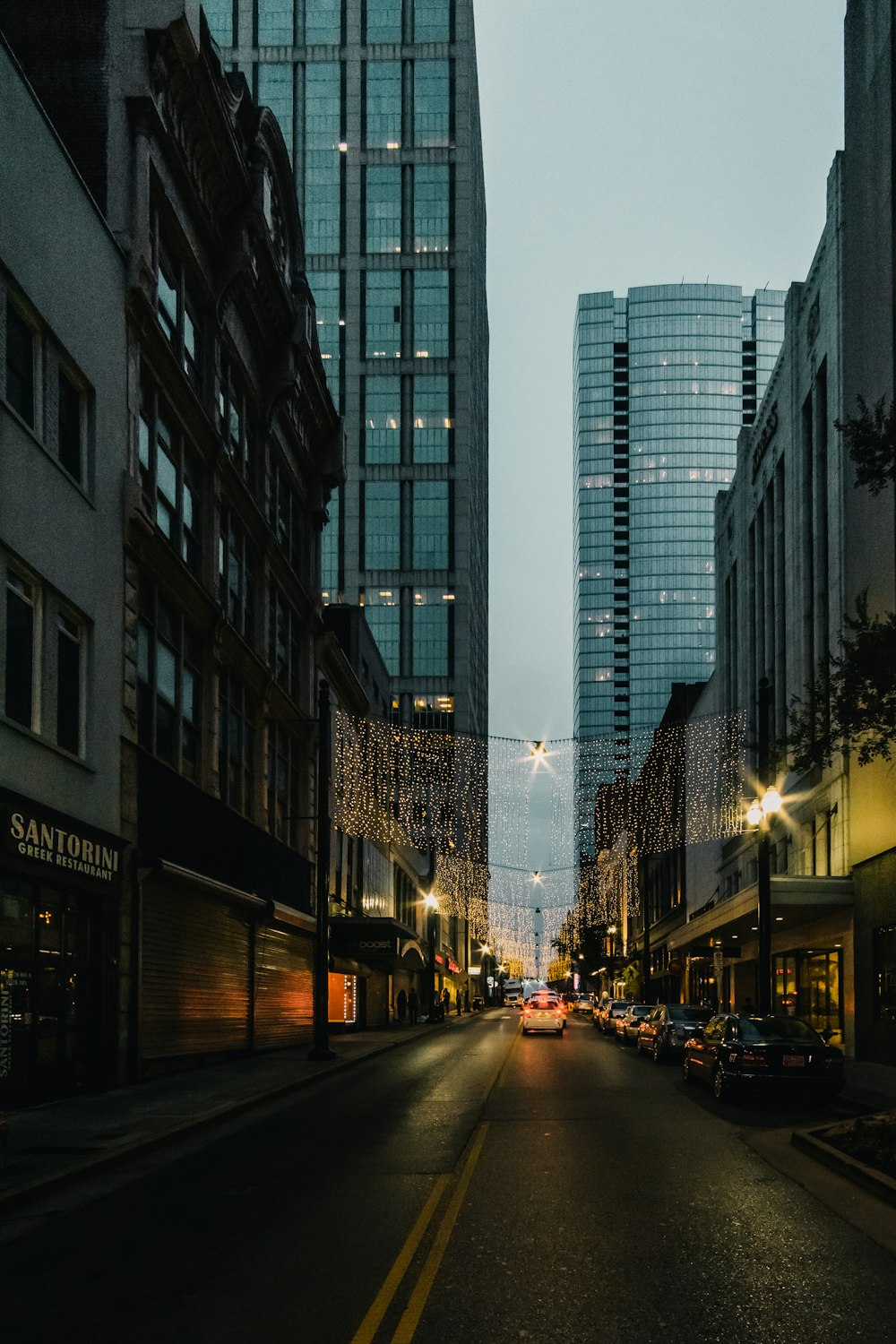 vehicles on road between buildings